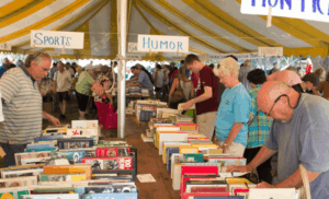 People browsing books under a tent